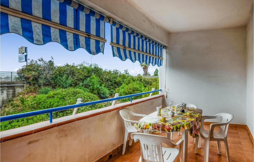 a dining room with a table and chairs and a large window at Lovely Apartment In Nocera Terinese in Nocera Terinese