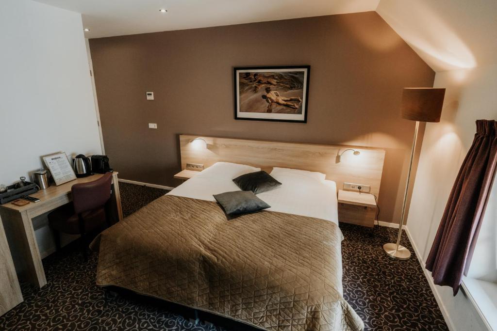 Postel nebo postele na pokoji v ubytování Herberg Erve Kots Logement