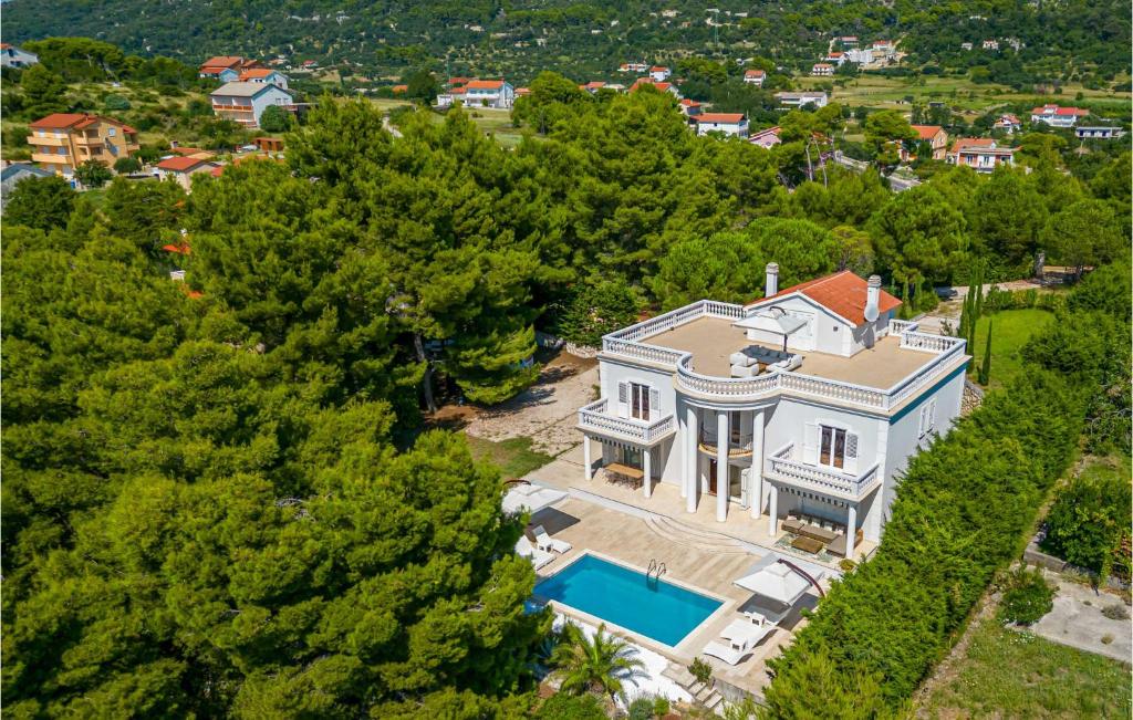 an aerial view of a house with a swimming pool at 6 Bedroom Lovely Home In Rab in Rab