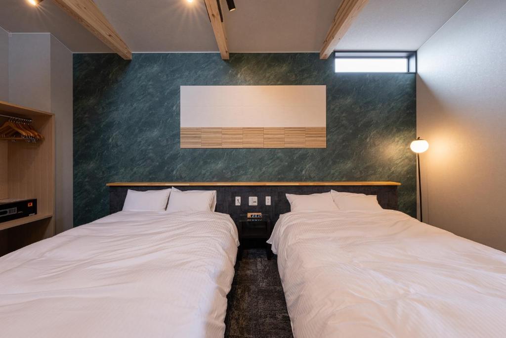 Postel nebo postele na pokoji v ubytování Hotel Soboku