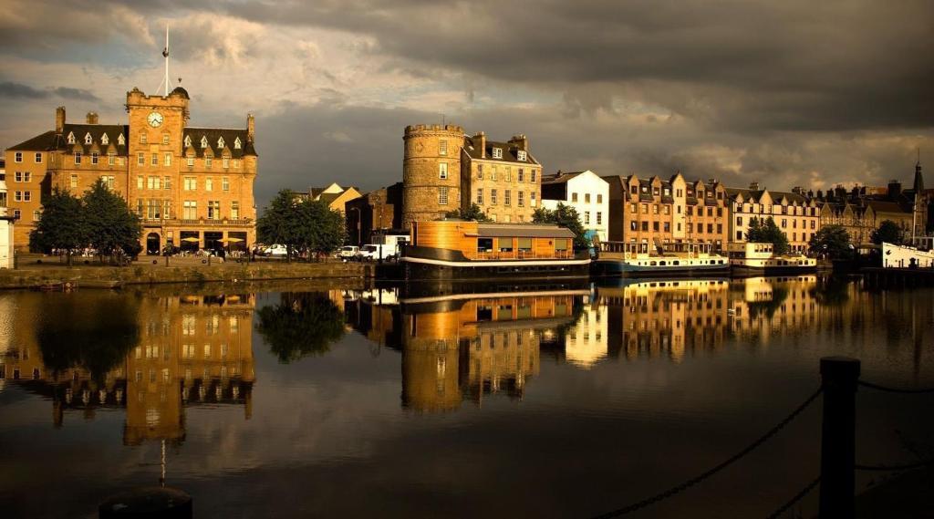 a city with a castle and a river with buildings at Shore View Apartment in Edinburgh
