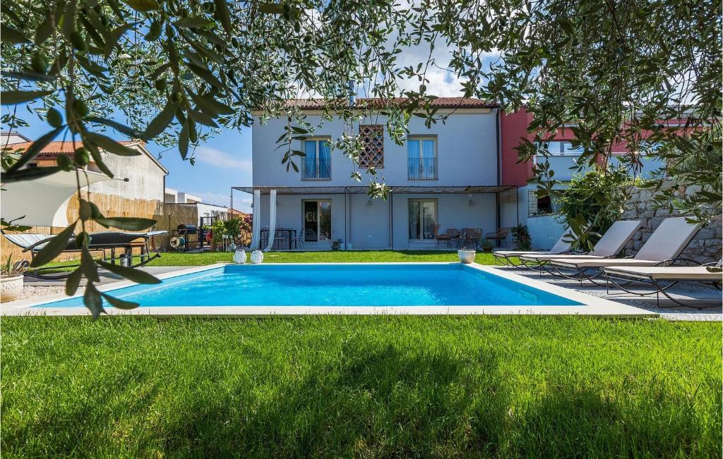 a swimming pool in front of a house at Villa Mediteranea in Umag