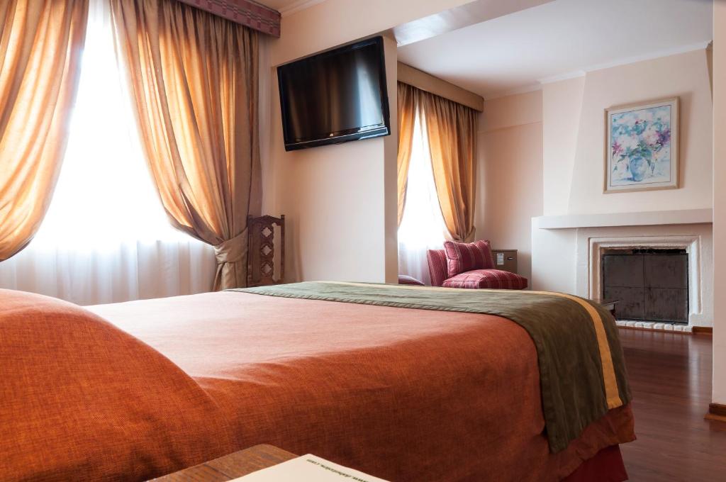 Postel nebo postele na pokoji v ubytování Hotel Francisco De Aguirre