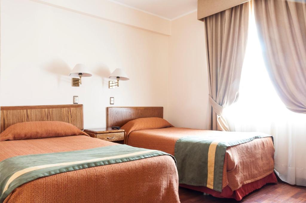 Postel nebo postele na pokoji v ubytování Hotel Francisco De Aguirre