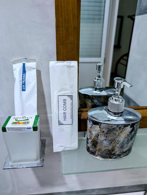 a bathroom with two sinks and a soap dispenser on a counter at Costels Mirissa in Mirissa