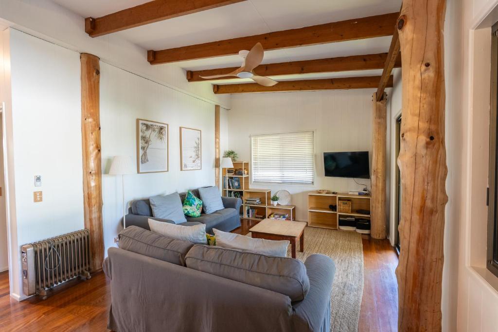 a living room with a couch and a tv at Tree & Sea sleeps 11 in Point Lookout