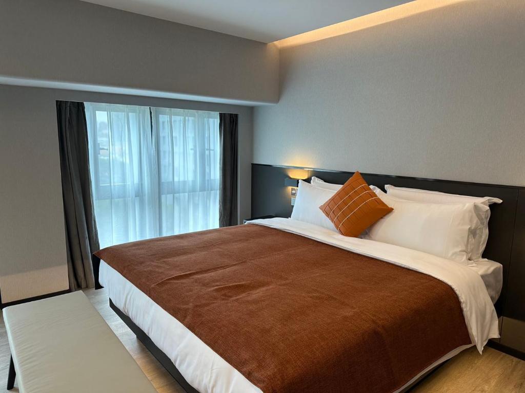 Postel nebo postele na pokoji v ubytování LlA Hotel Liang Jun Plaza, Xixiang Avenue