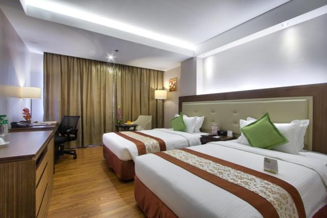 Postel nebo postele na pokoji v ubytování ACE Hotel and Suites
