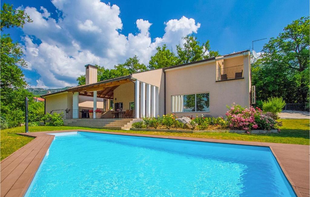 a house with a swimming pool in front of a house at Villa Vesna in Buzet