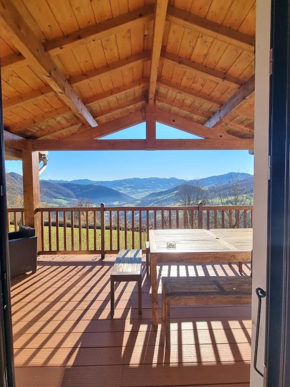 a patio with a table and a bench on a deck at Gîte Xuritenborda 7 personnes avec vue exceptionnelle sur les montagnes basque, Lits 180 King Size in Ossès
