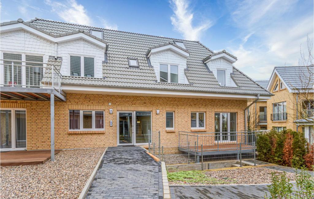 a brick house with a gray roof at Lovely Apartment In Timmendorfer-Strand in Timmendorfer Strand