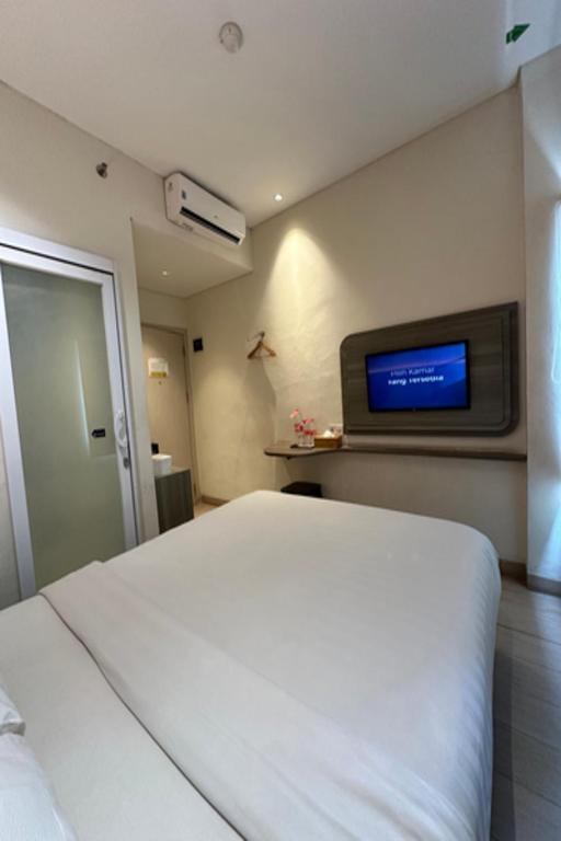 Postel nebo postele na pokoji v ubytování Hotel 88 Alun Alun Bandung By WH