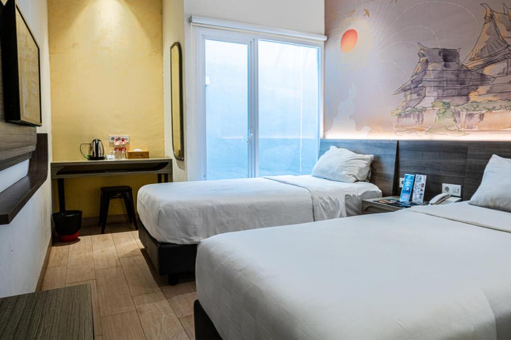 Postel nebo postele na pokoji v ubytování Hotel 88 Alun Alun Bandung By WH