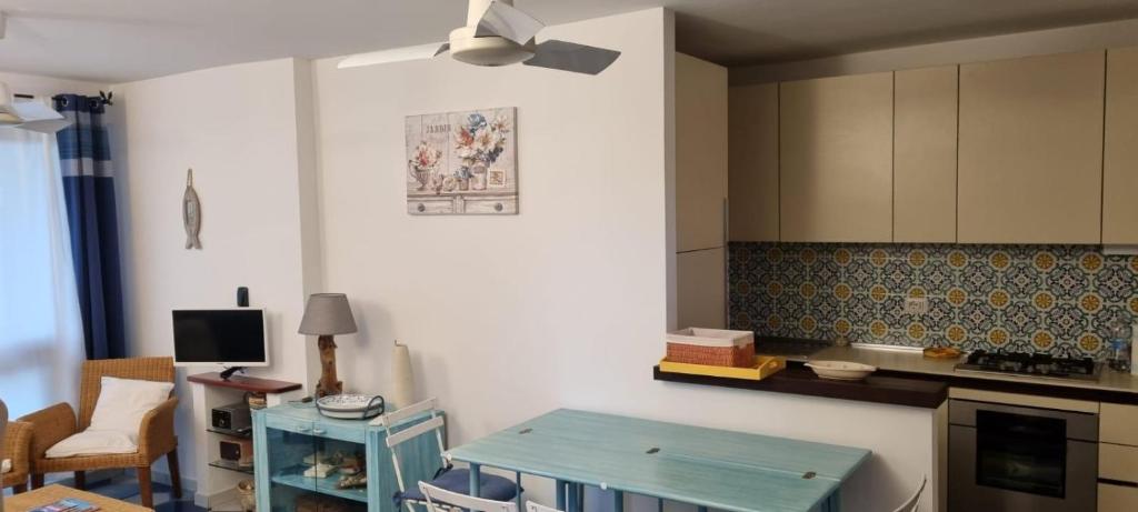 a kitchen with a blue table in a room at Casa vacanza da Gabry sardinia in Porto Rotondo