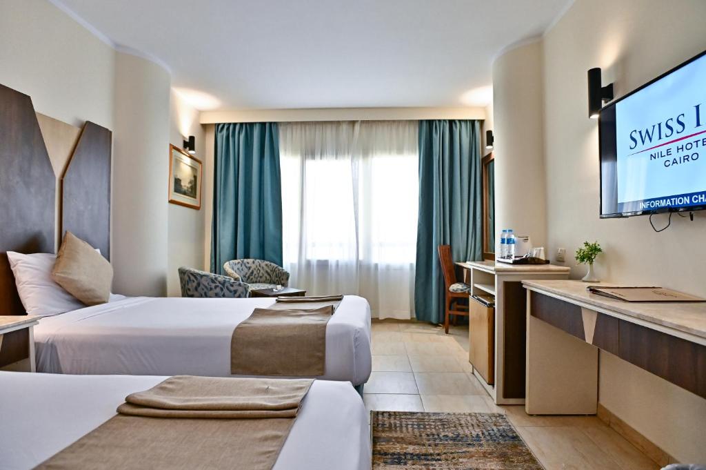 Postel nebo postele na pokoji v ubytování Swiss Inn Nile Hotel