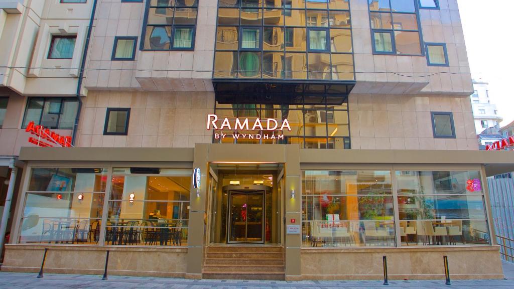 a tall building with a sign on it at Ramada By Wyndham İstanbul Taksim in Istanbul