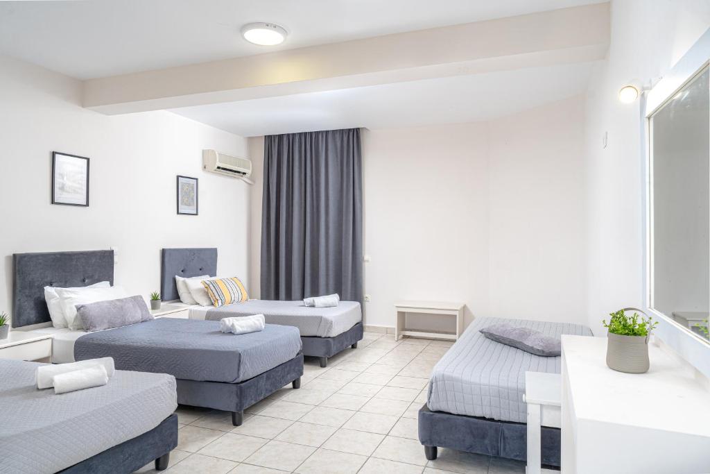 Postel nebo postele na pokoji v ubytování Blue Palm Hotel