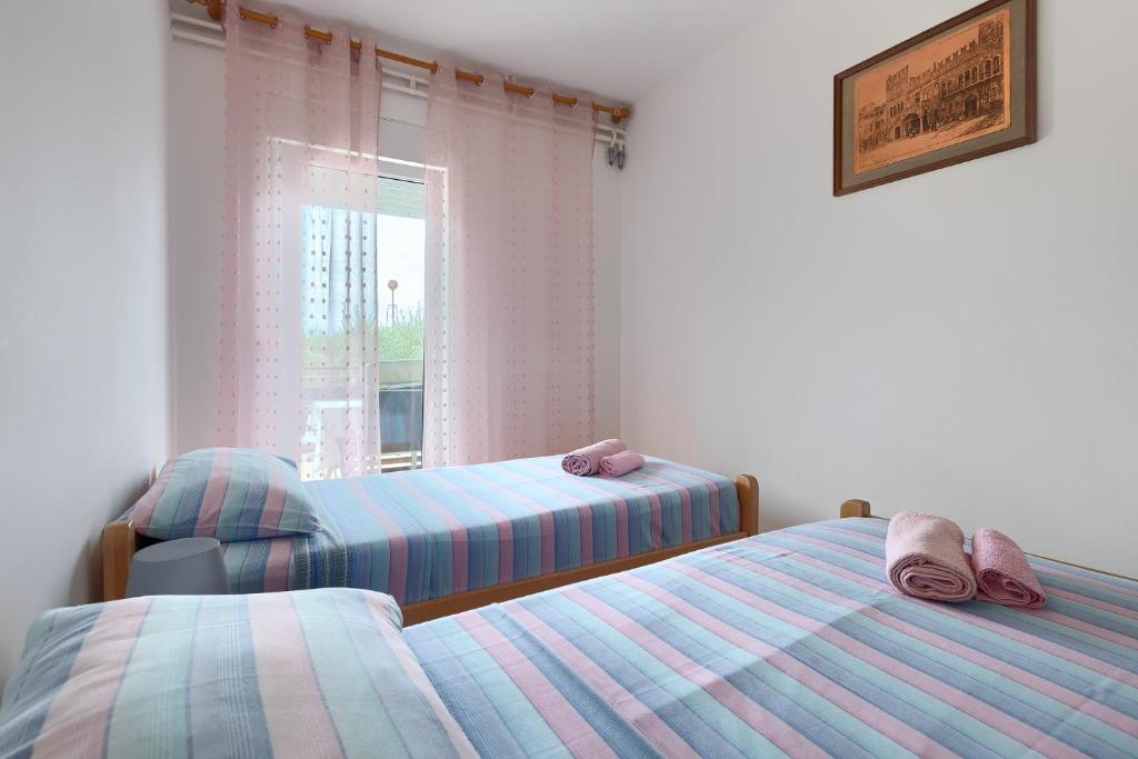 Łóżko lub łóżka w pokoju w obiekcie Apartments Erla