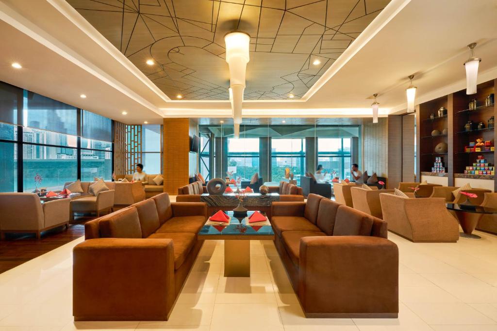 A central lobby seating area with leather sofas and broad windows.
