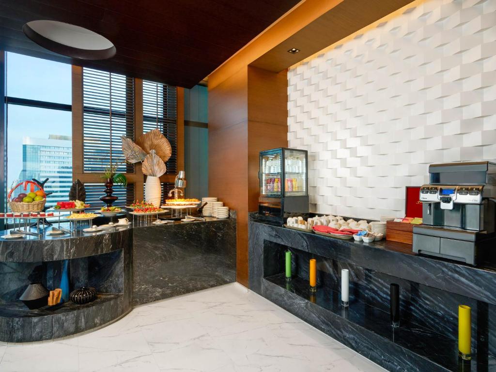 A compact buffet station with fruit, pastries, drinks and coffee service.