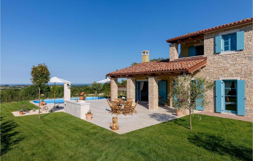 a stone house with a patio and a pool at Villa Toscana in Umag