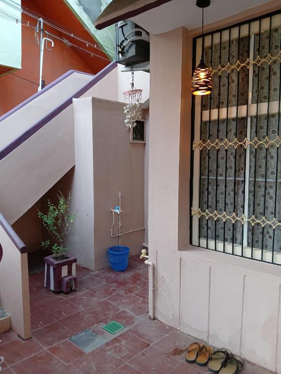 a pair of sandals sitting on the floor in front of a building at Kallidai Home Stay Kumbakonam in Kumbakonam