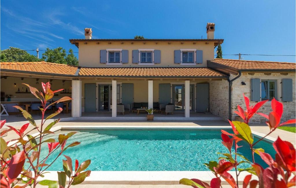 a villa with a swimming pool in front of a house at Villa Morosini in Rovinj