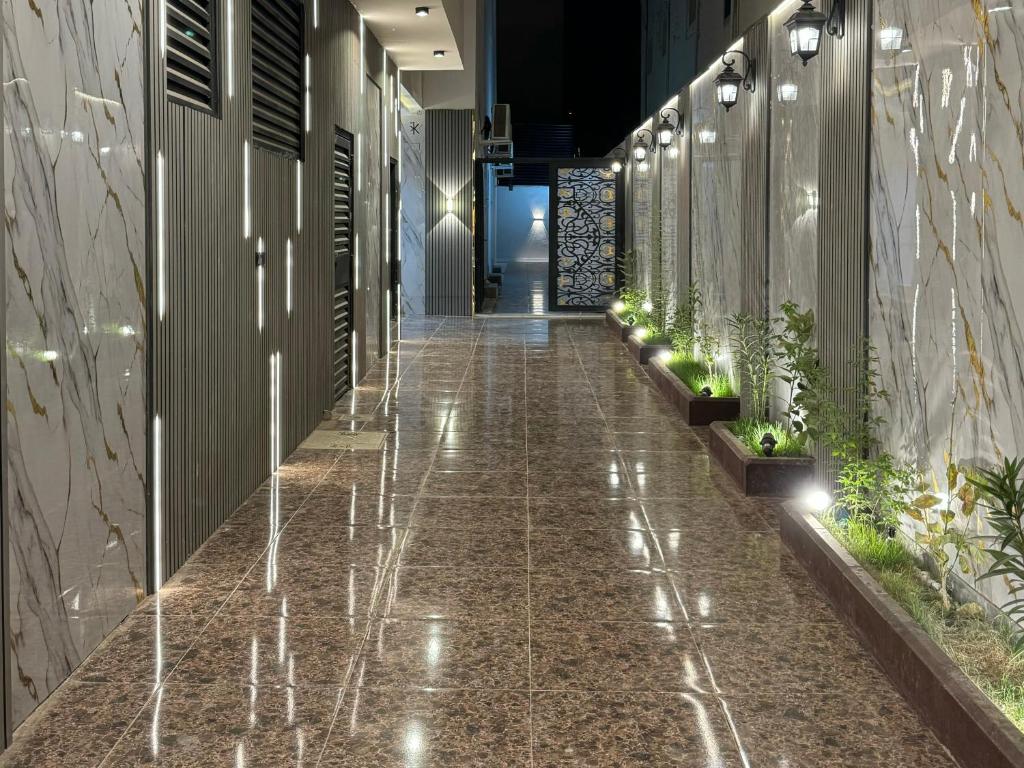 a corridor of a building with plants on the walls at استديو هادئ in Riyadh