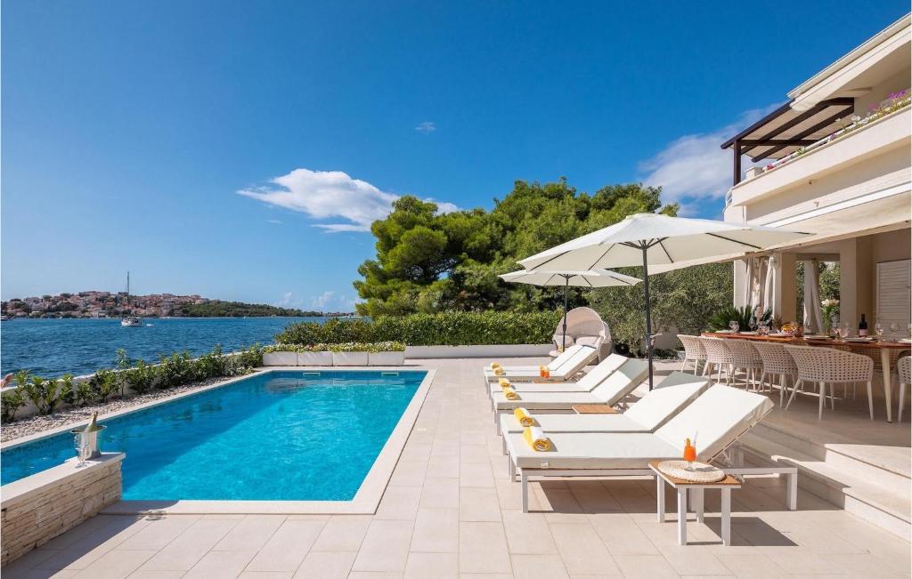 a house with a swimming pool and a patio at Villa Naranca in Split