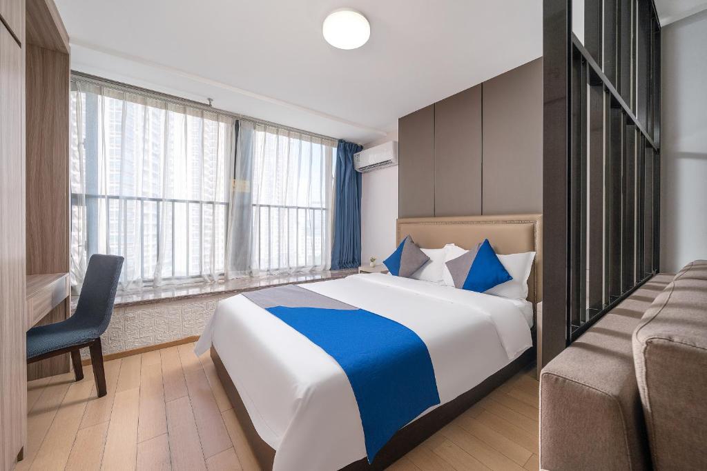 Postel nebo postele na pokoji v ubytování Hantao AI Select International Apartment