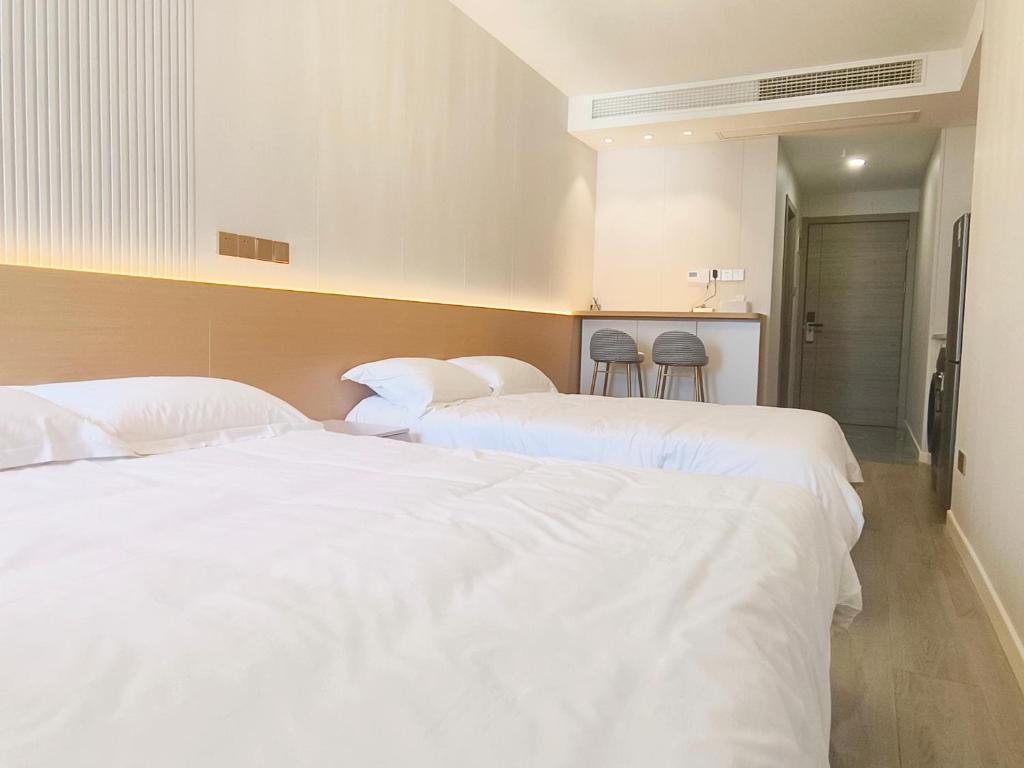 Postel nebo postele na pokoji v ubytování 彩虹小居陆家嘴店
