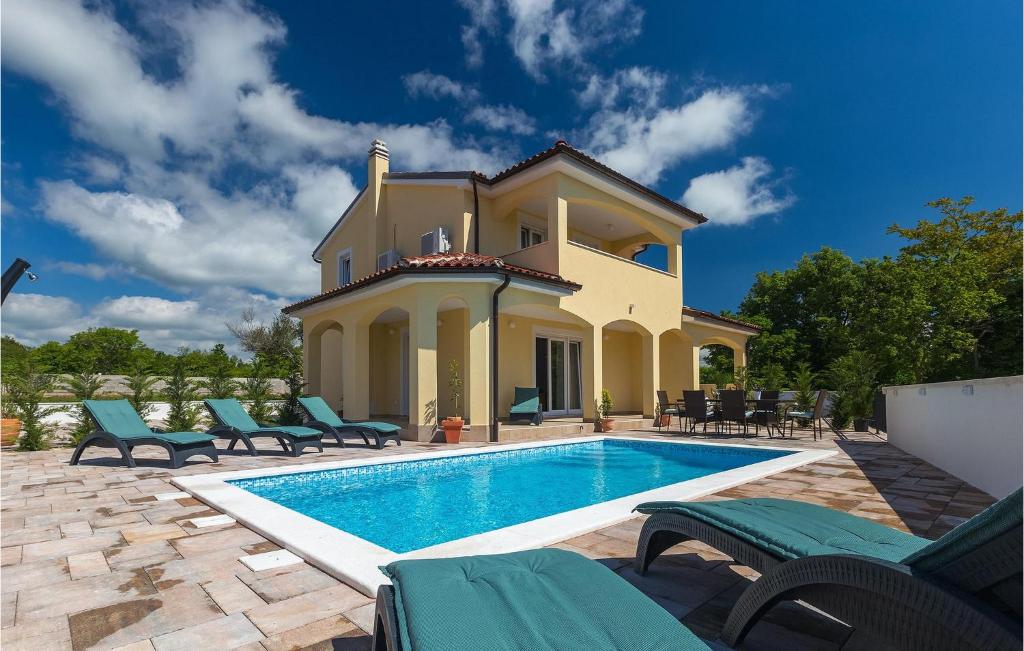 a villa with a swimming pool in front of a house at Villa Florami in Pula