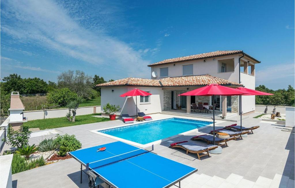 a villa with a swimming pool and a house at Villa Lena in Sarići