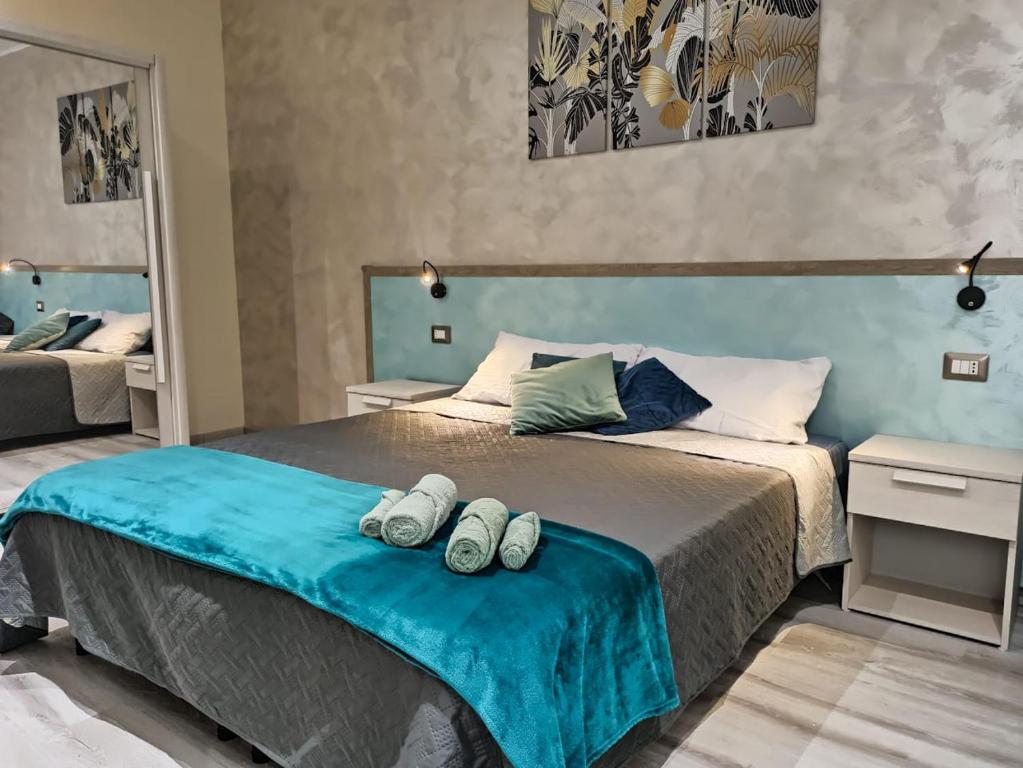 a bedroom with a bed with two pairs of shoes on it at Le Nonne HOUSE - Assemini - free parking in Assemini