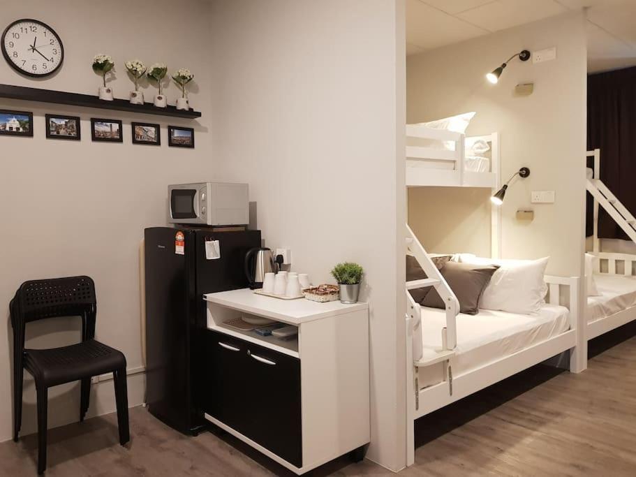 a dorm room with a bunk bed and a desk at Heritage Studio in UNESCO Zone near to StreetArt & Town 2 in George Town