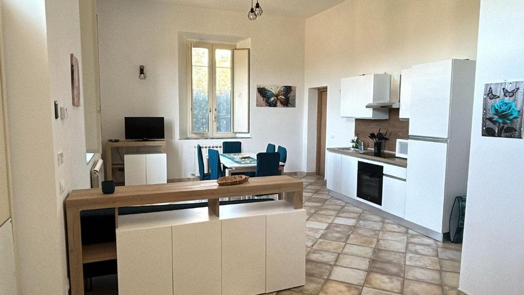 a kitchen and living room with a table in a room at La Toscana sotto il castello in Lucca