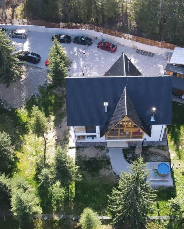 an overhead view of a house with a black roof at Luna Retreat in Muntele Cacovei