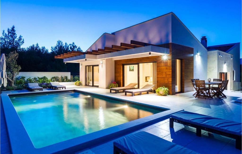 a large swimming pool in front of a house at Villa Bianca in Zadar