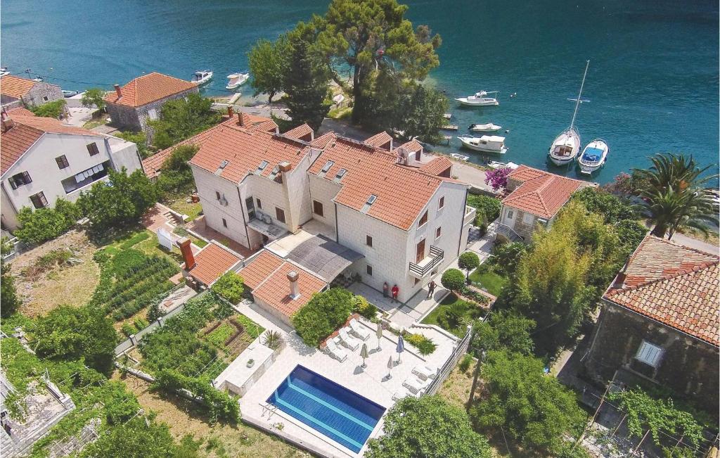 an aerial view of a house with a swimming pool at Holiday Home Obuljeno Donje Iii in Mokošica