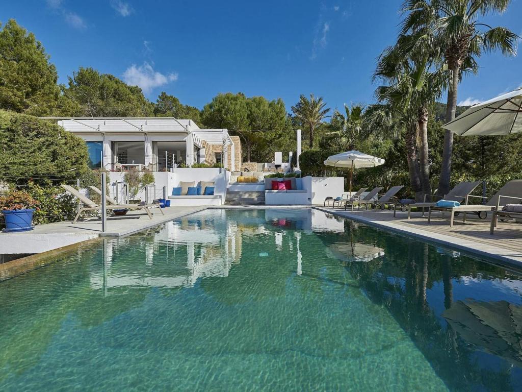 a swimming pool with clear blue water in a house at Holiday Home Ibiza near Cala Tarida Beach in Sant Josep