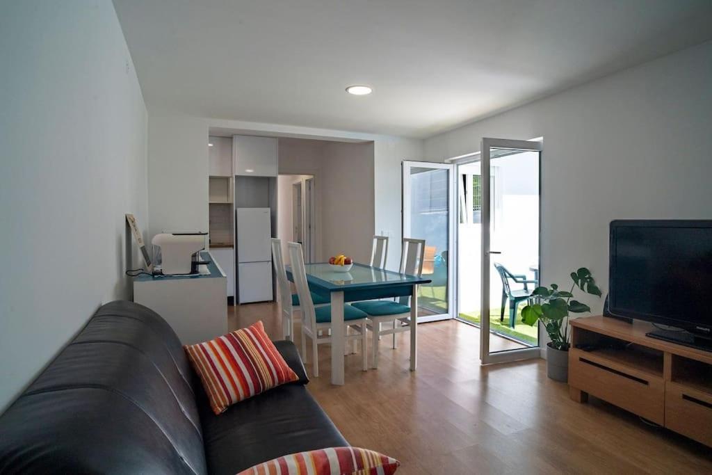 a living room with a couch and a table at Casa da fonte in Vila Nova de Gaia