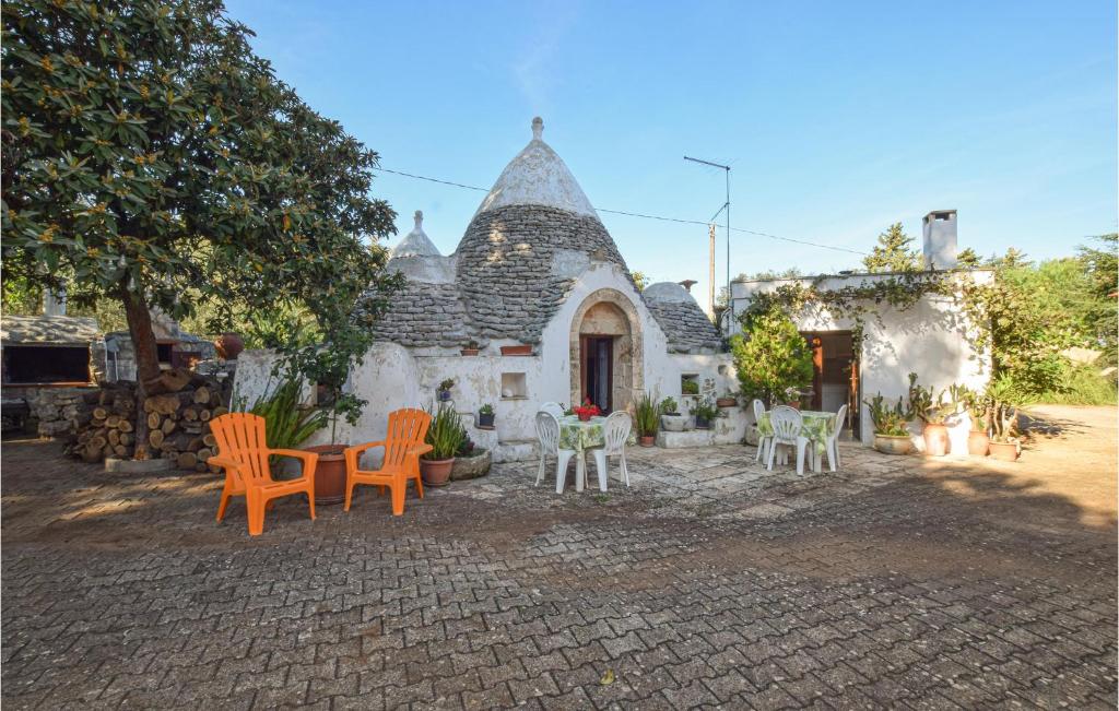 a group of chairs and tables in front of a building at Trullo 1474 in Ceglie Messapica