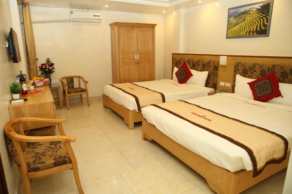 Giường trong phòng chung tại Sapa Snow Hotel