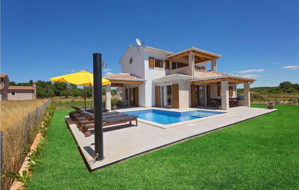 a villa with a swimming pool and a house at Villa Fortuna in Funtana