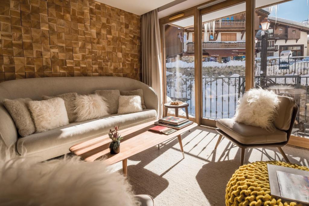 a living room with a couch and a table at Coeur de Megève in Megève