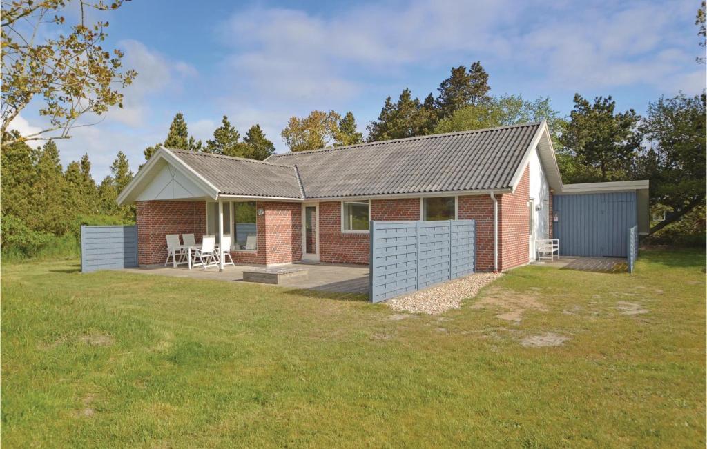 a red brick house with a large yard at Holiday Home Sandtoftevej Blåvand Ix in Blåvand
