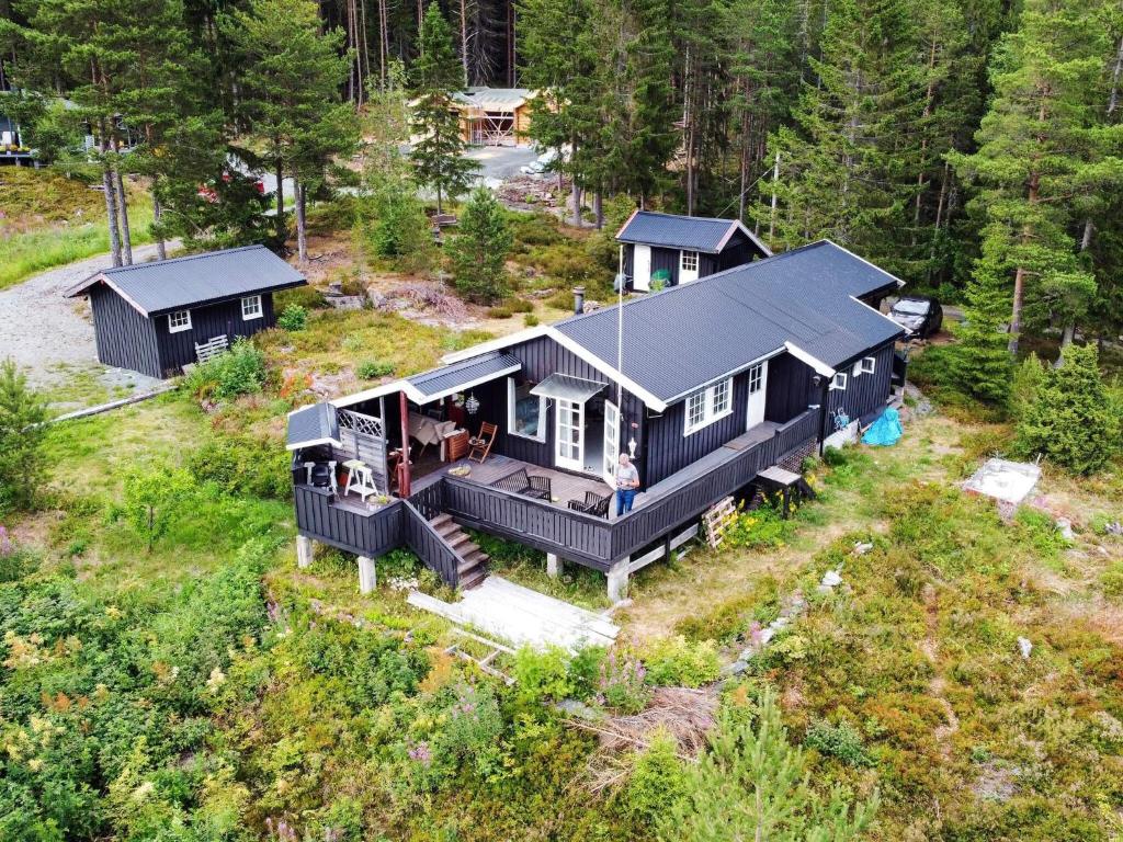 an aerial view of a black house with a deck at 8 person holiday home in frosta in Vollen