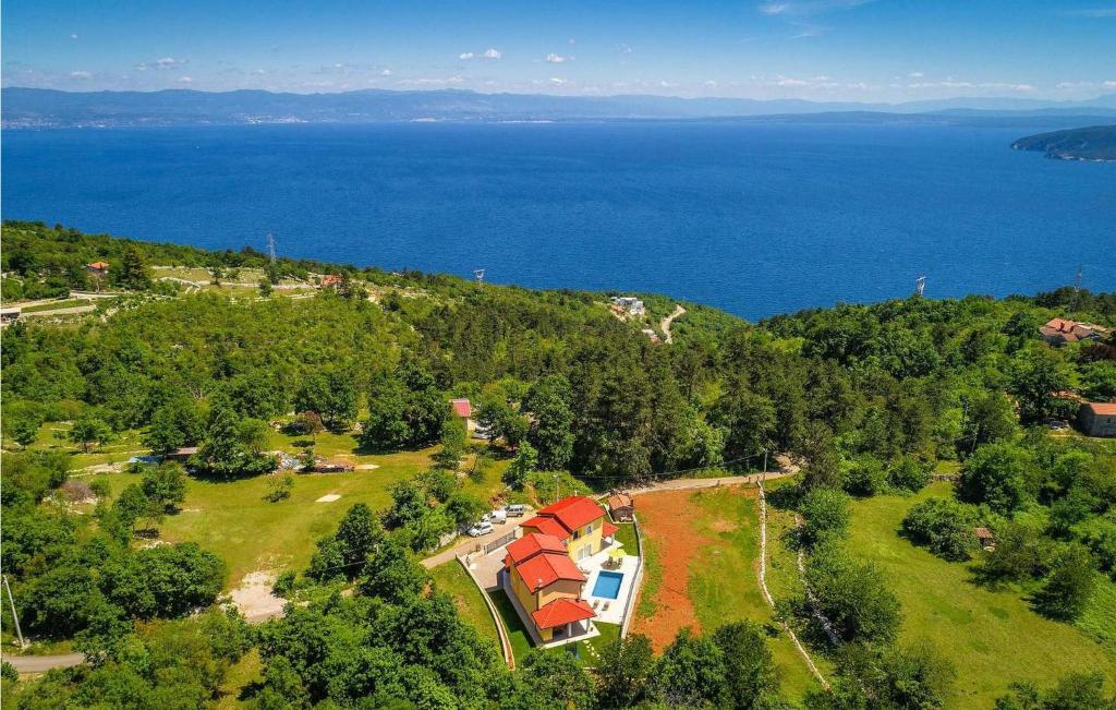 an aerial view of a house on a hill near the water at Villa Terra in Mošćenička Draga