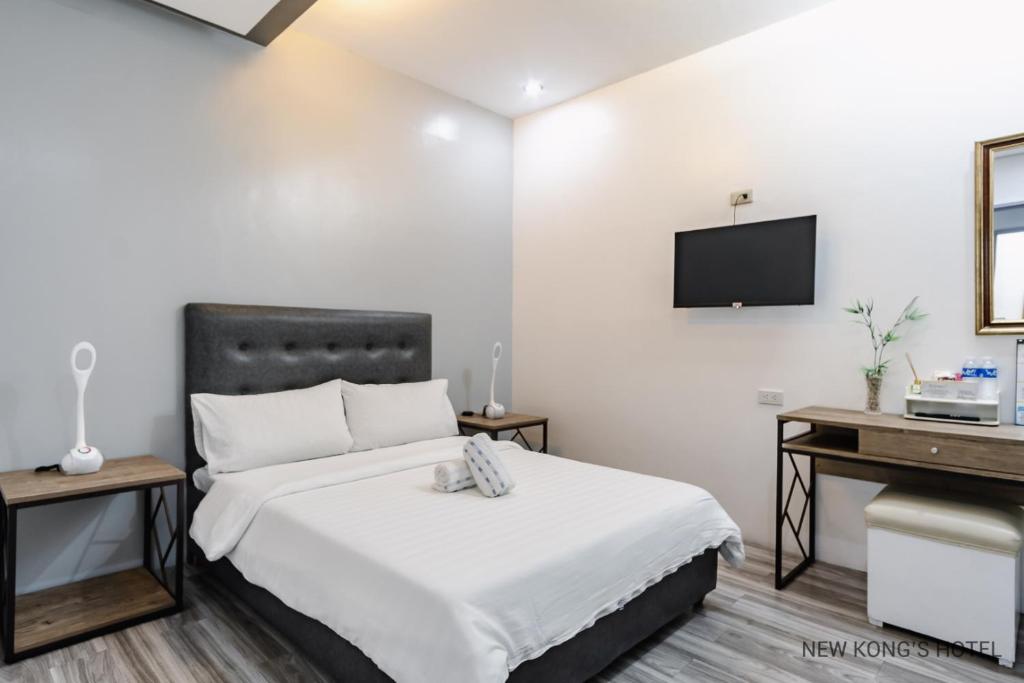 Postel nebo postele na pokoji v ubytování New Kong's Hotel