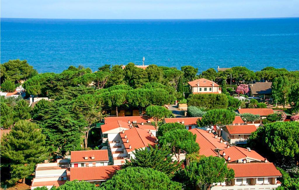 a town with red roofs and trees and the ocean at Bilo 5 in Orbetello